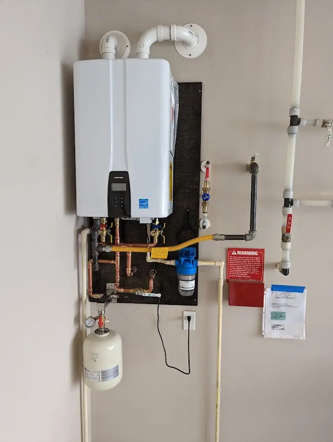 Professional plumber installing copper piping in a Wellington home